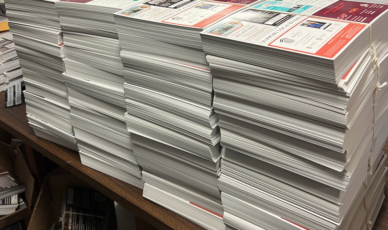 Stacks of printed local business postcards